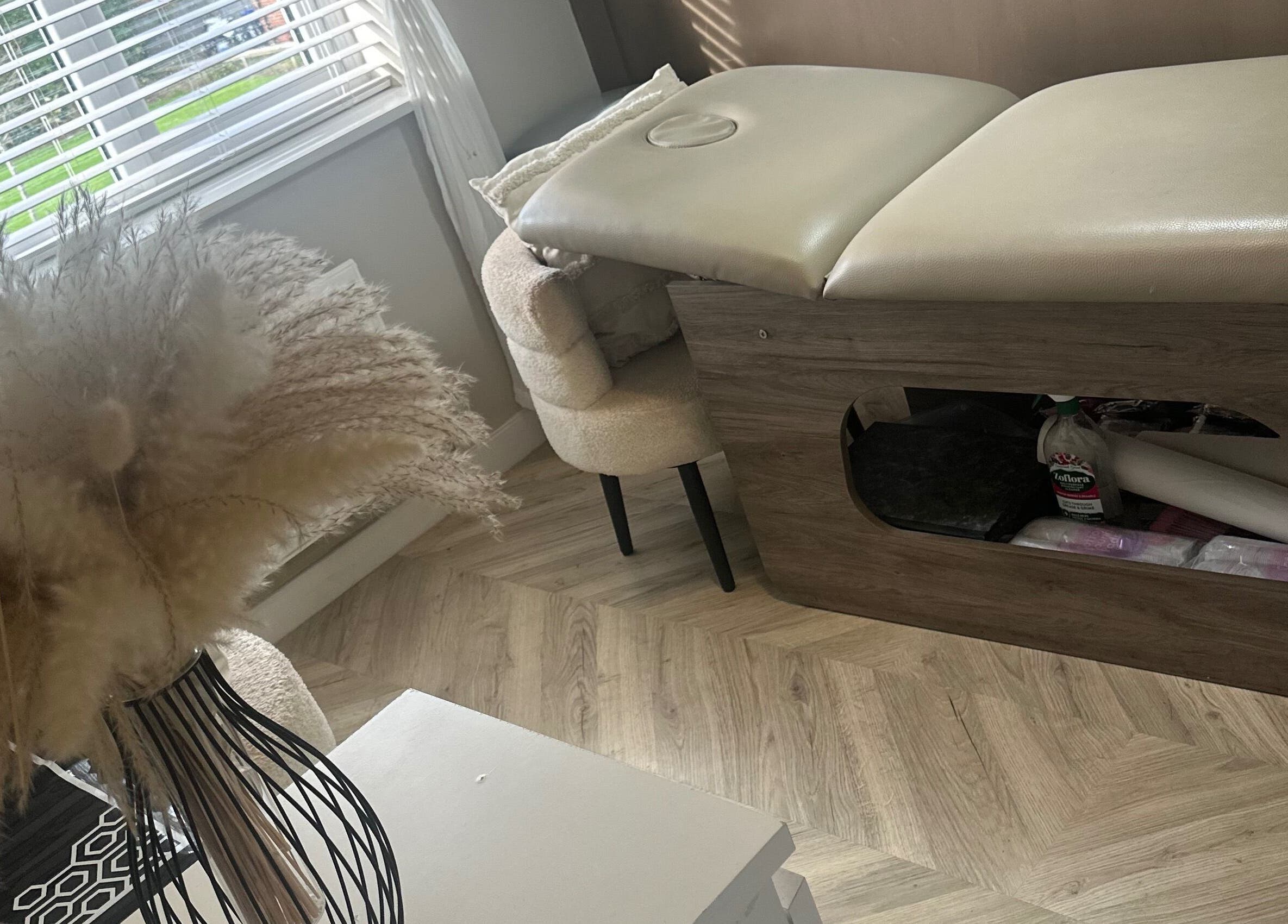 Relaxing spa room at Haus Of Lyons, Spennymoor, England, GB with a cozy treatment table and soft decor.