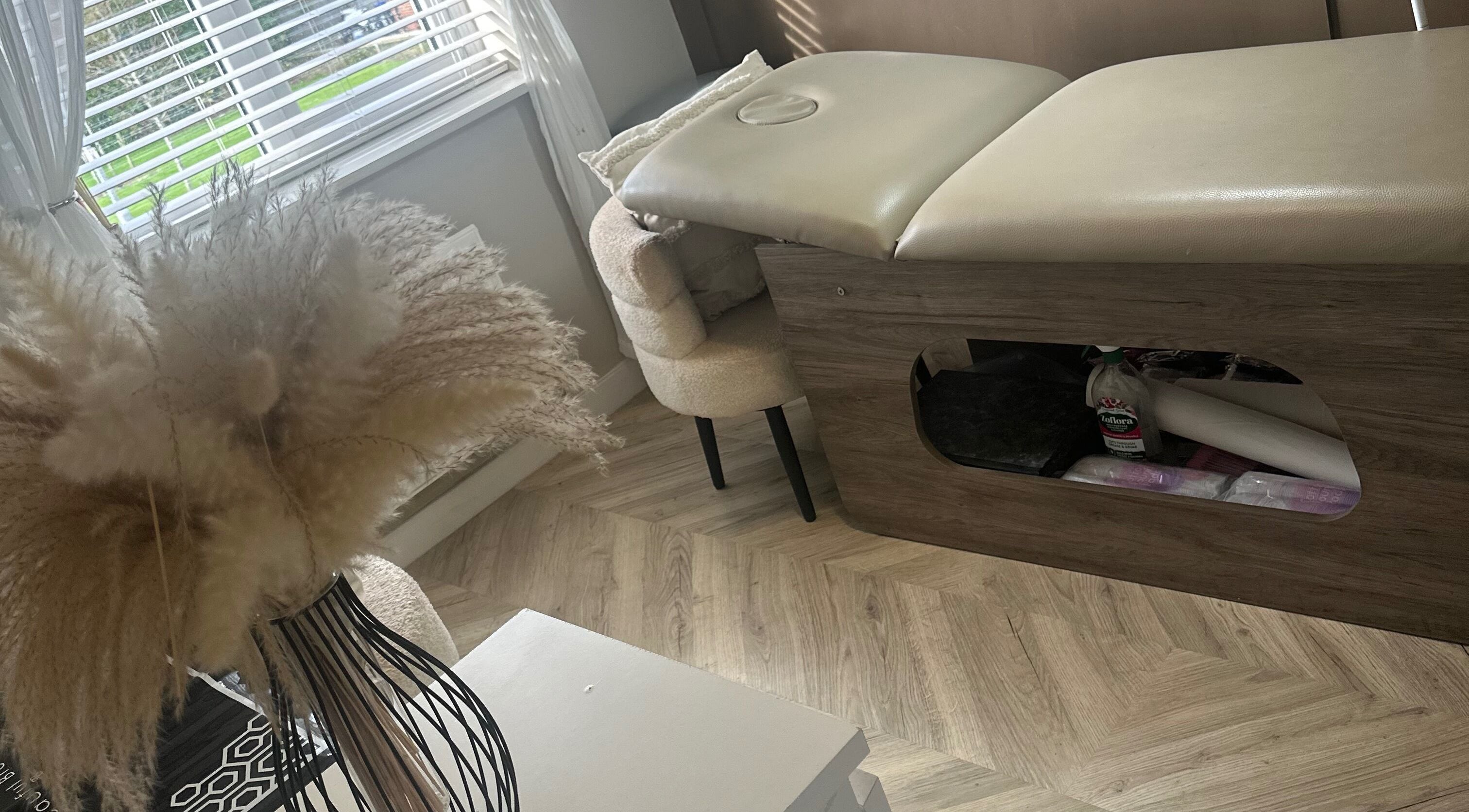 Relaxing spa room at Haus Of Lyons, Spennymoor, England, GB with a cozy treatment table and soft decor.