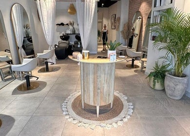 Interior of Moss Hair Artistry in Neutral Bay, New South Wales, showcasing modern salon chairs and lush plants.