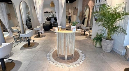 Interior of Moss Hair Artistry in Neutral Bay, New South Wales, showcasing modern salon chairs and lush plants.