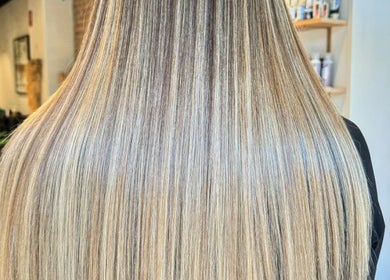 Sleek blonde hair, expertly styled at Moss Hair Artistry, Neutral Bay, New South Wales, AU, showcasing smooth finish.