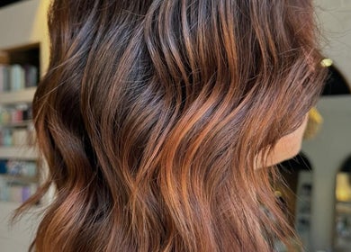 Stylish wavy hairstyle at Moss Hair Artistry in Neutral Bay, New South Wales, AU, showcasing vibrant color.