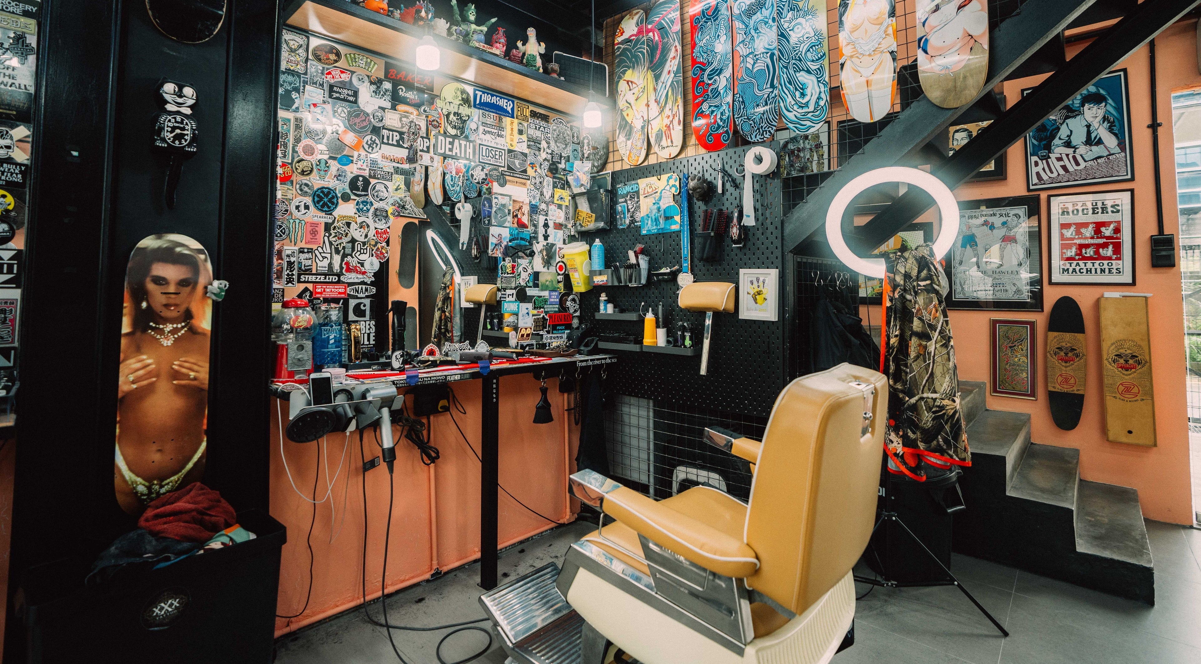 Eclectic barbershop interior at Grease Monkey - 15 Mayo Street, Singapore, SG with skateboards and vintage decor.