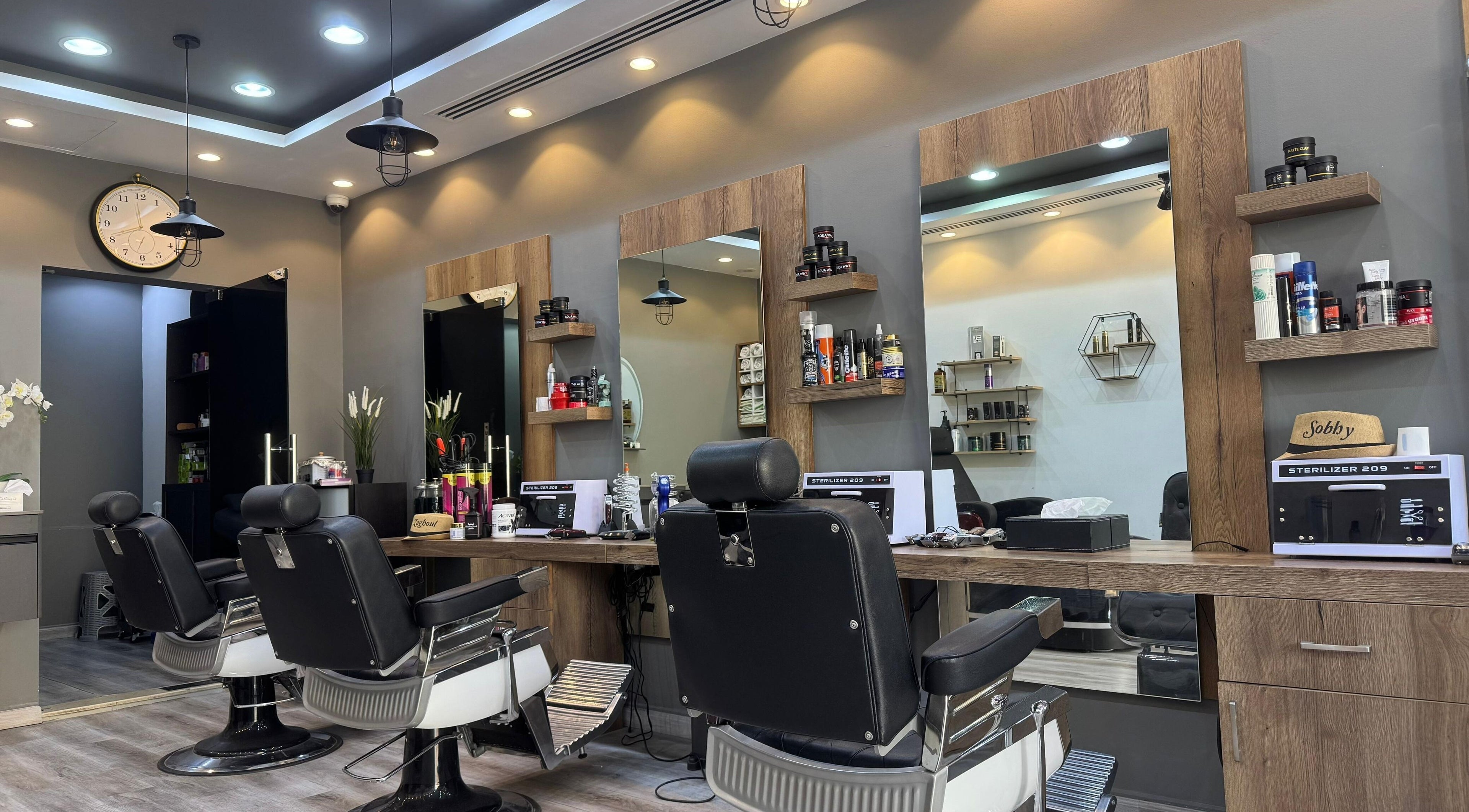 Barberhood Gents Salon in Dubai, Dubai, AE, showcases sleek, modern barber chairs and styling stations.