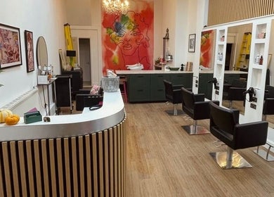 Modern salon interior at Sarah Roberts, London, England, GB featuring styling chairs and artistic decor.