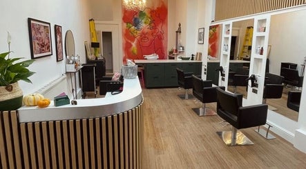 Modern salon interior at Sarah Roberts, London, England, GB featuring styling chairs and artistic decor.