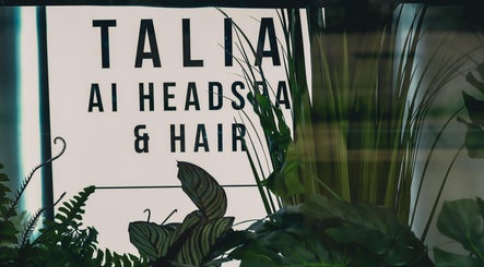 Talia Hair and Beauty Salon entrance sign in Singapore, SG, amidst lush greenery.