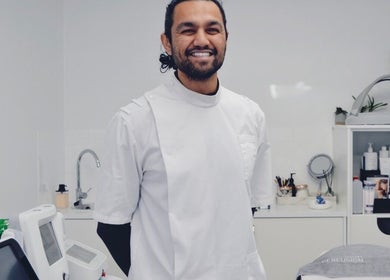 Professional at Mistry Osteopath South Ealing clinic in London, England, GB, surrounded by wellness equipment.