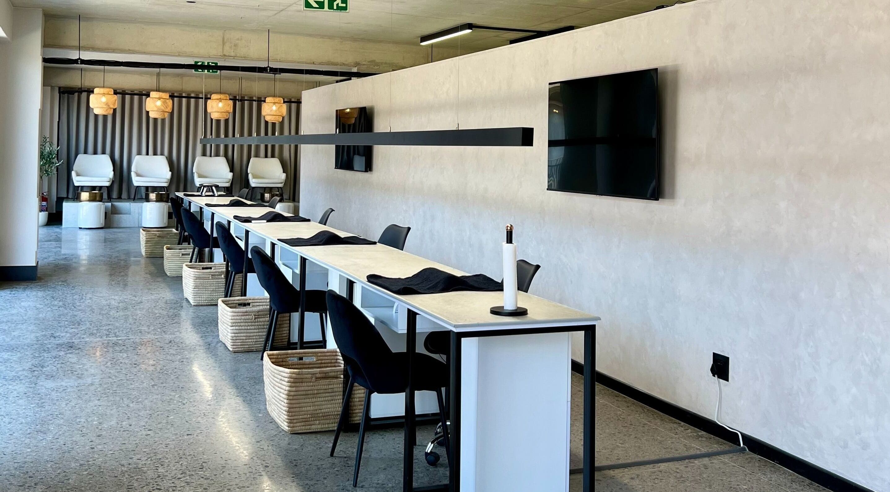Modern nail bar setup at SALT Beauty Bar, Centurion, Gauteng, ZA with elegant seating and lighting.