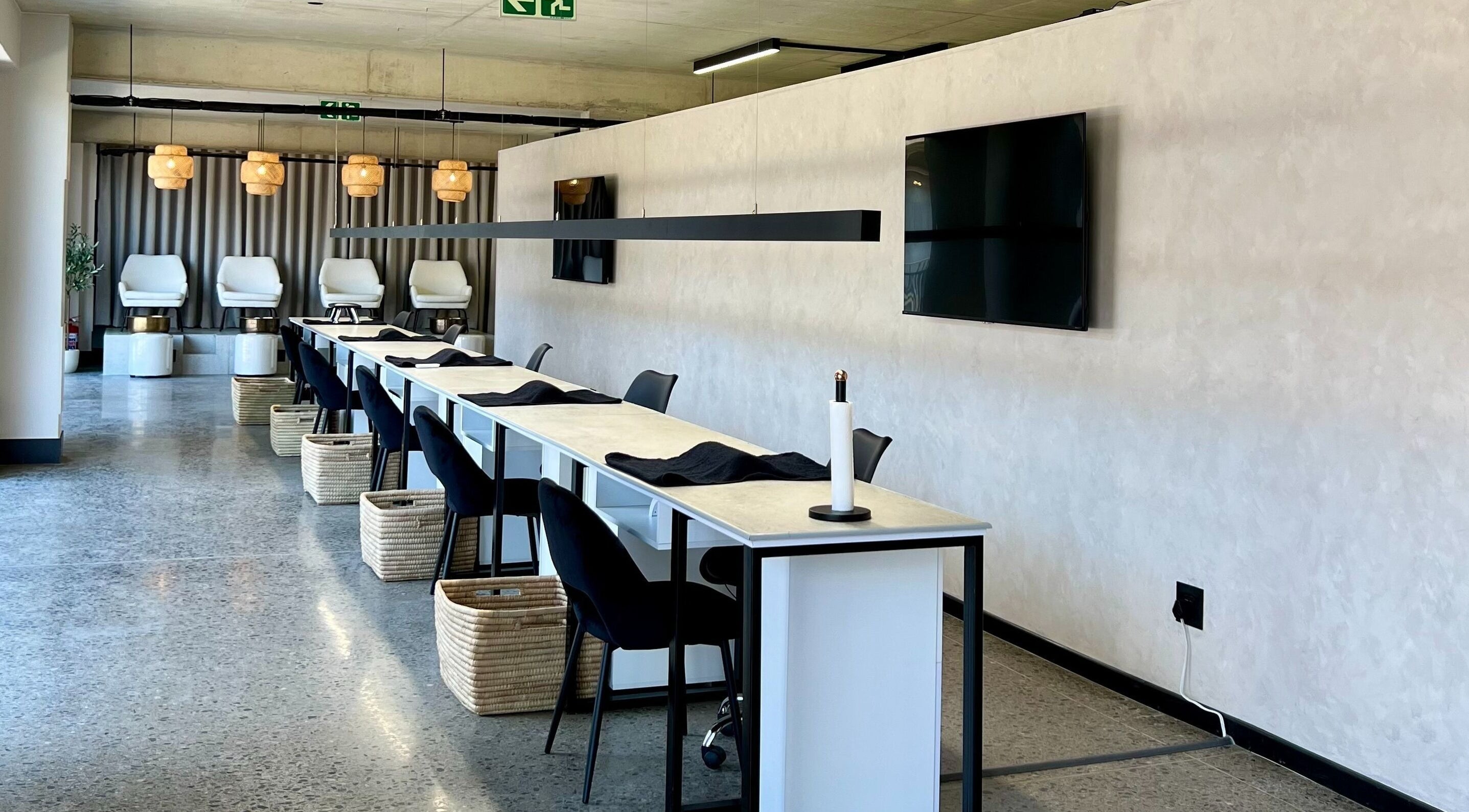 Modern nail bar setup at SALT Beauty Bar, Centurion, Gauteng, ZA with elegant seating and lighting.