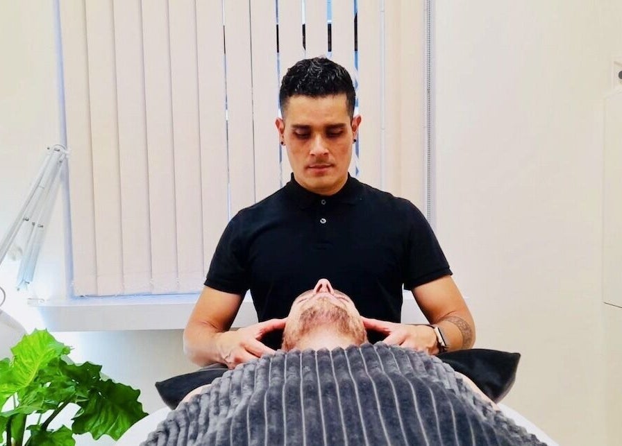 Massage therapist at Yonathan Massage Therapy in London, England, GB providing a relaxing neck treatment.