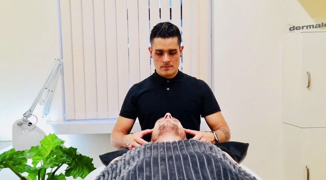 Massage therapist at Yonathan Massage Therapy in London, England, GB providing a relaxing neck treatment.