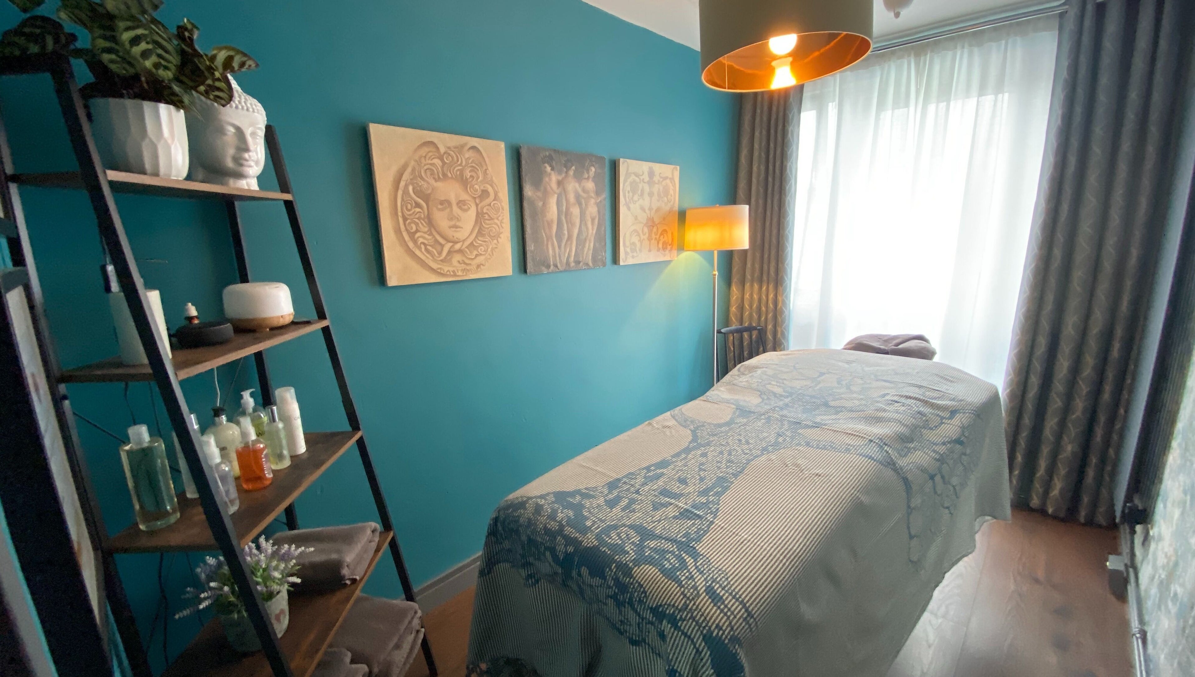 Serene massage room at Yonathan Massage Therapy, London, England, GB with decor and ambient lighting.