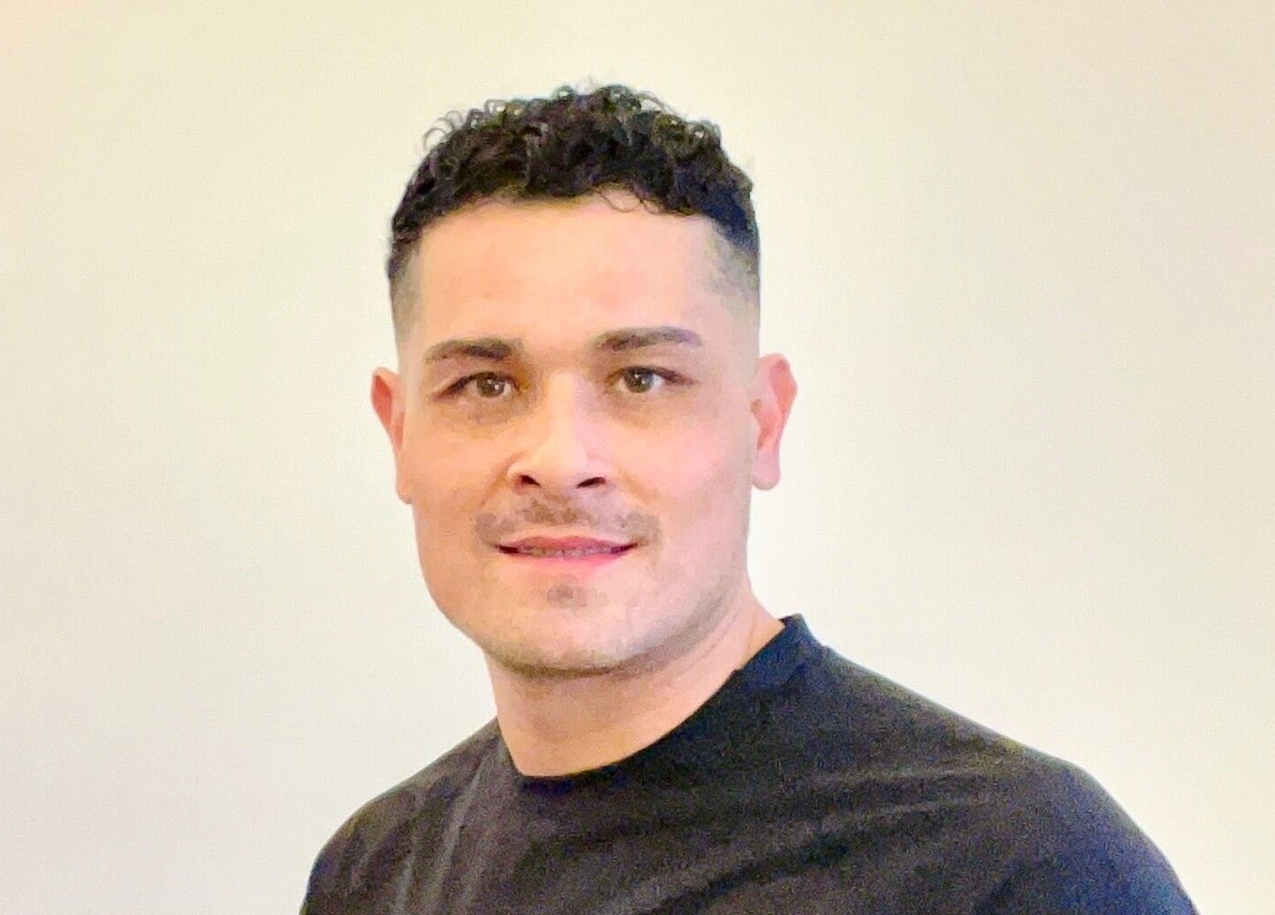 Therapist at Yonathan Massage Therapy, London, England, GB, welcoming clients with a friendly smile.