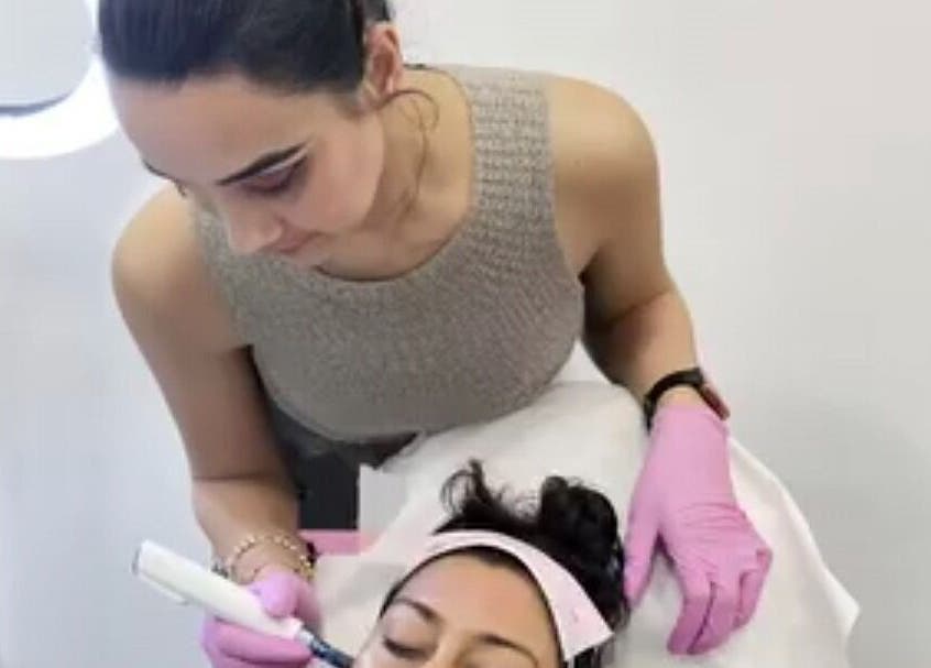 Glowtonix skincare treatment in Borehamwood, England, GB. Aesthetician performs facial with care.