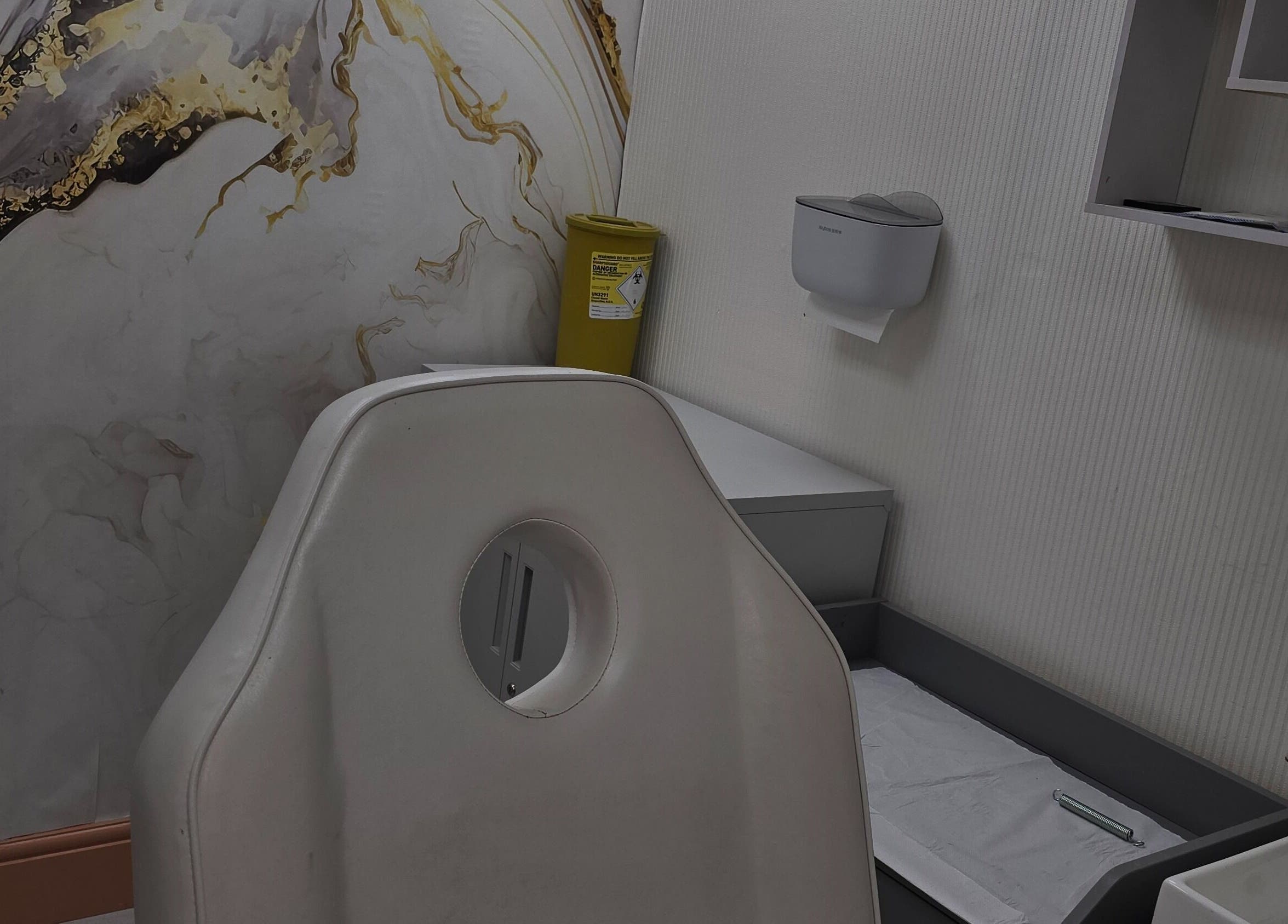 Sleek wellness room at Glowtonix, Borehamwood, England, GB featuring modern chair and elegant decor.