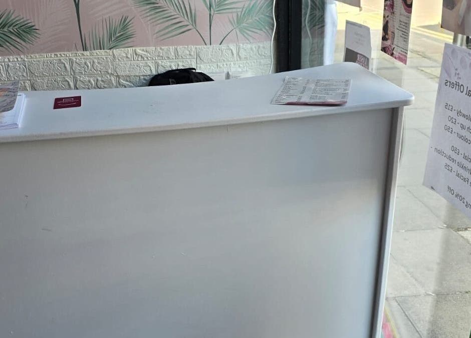 Reception desk at Glowtonix, Borehamwood, England, GB. Stylish and inviting space for beauty treatments.