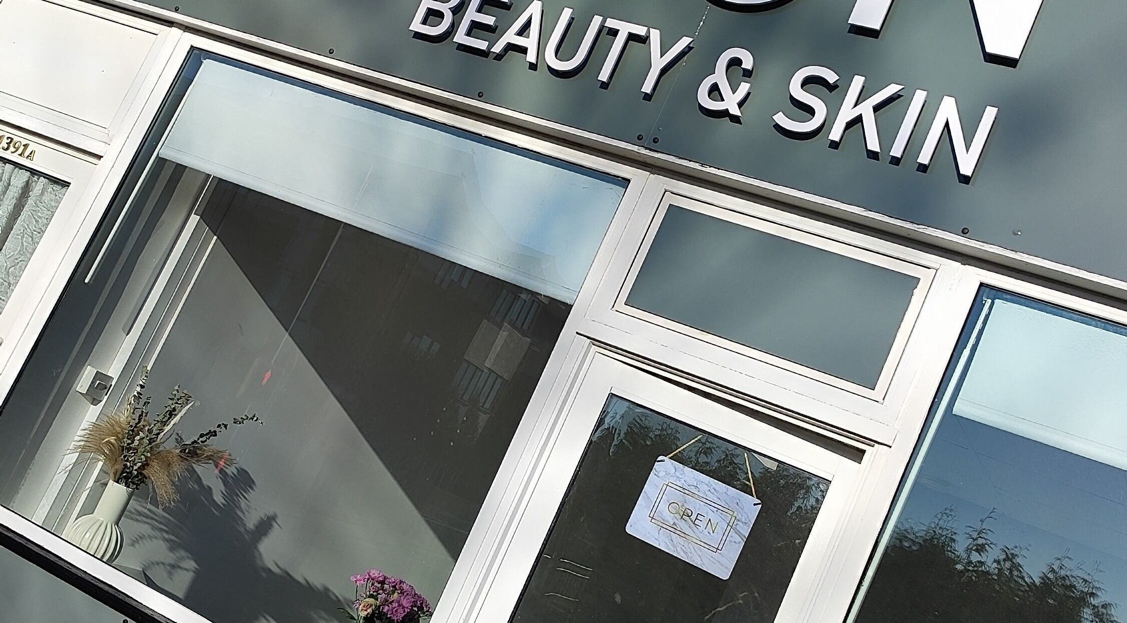 Front of Icon Beauty & Skin, Southend on Sea, England. Glass doors with open sign and decorative plants.