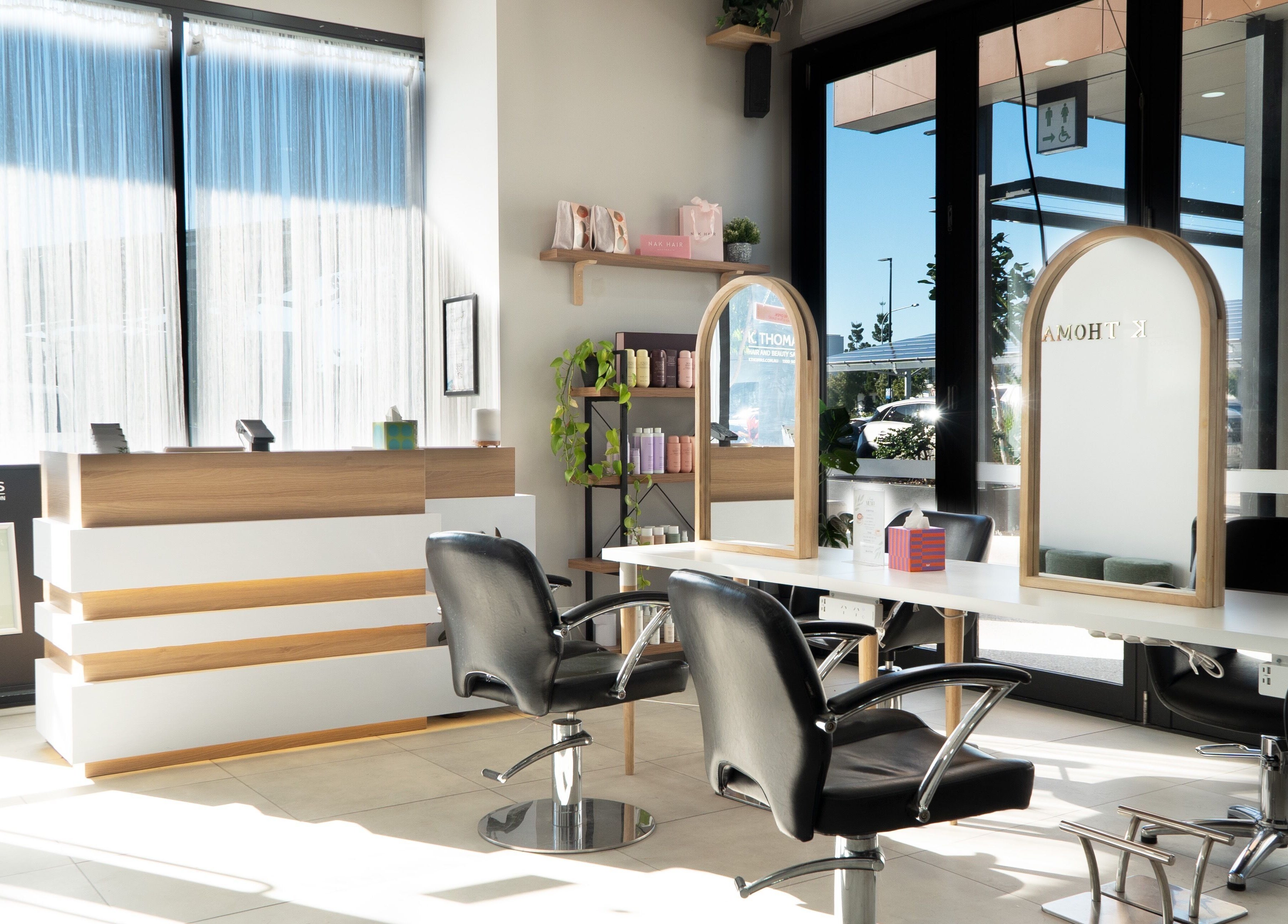 Bright salon interior at K Thomas Capestone Village, Mango Hill, Queensland, AU with sleek chairs and mirrors.