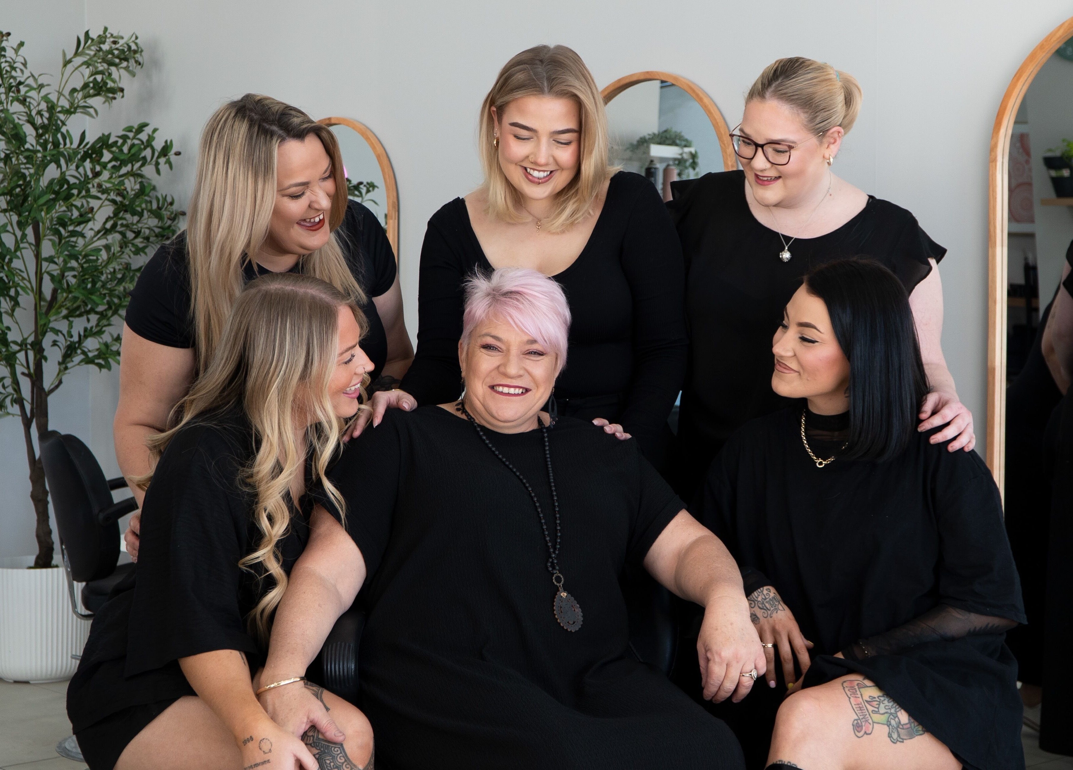 K Thomas Capestone Village team bonding at Mango Hill, Queensland, AU surrounded by mirrors and greenery.