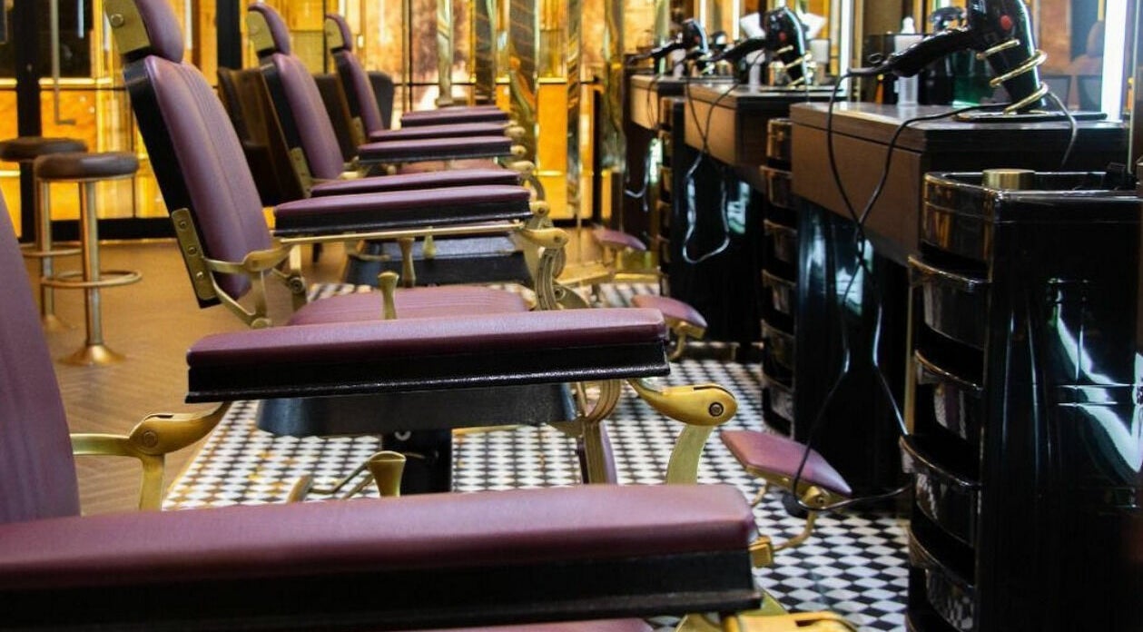 Barber chairs in Amber Gents Salon, Two Seasons Hotel, Dubai, Dubai, AE, offering luxury grooming services.