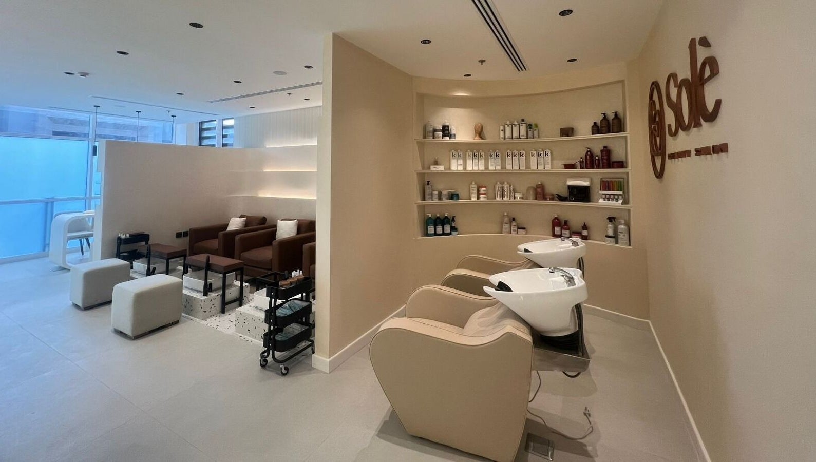 Elegant beauty salon interior at Solè, الظهران, المنطقة الشرقية, SA, featuring chairs and product shelves.