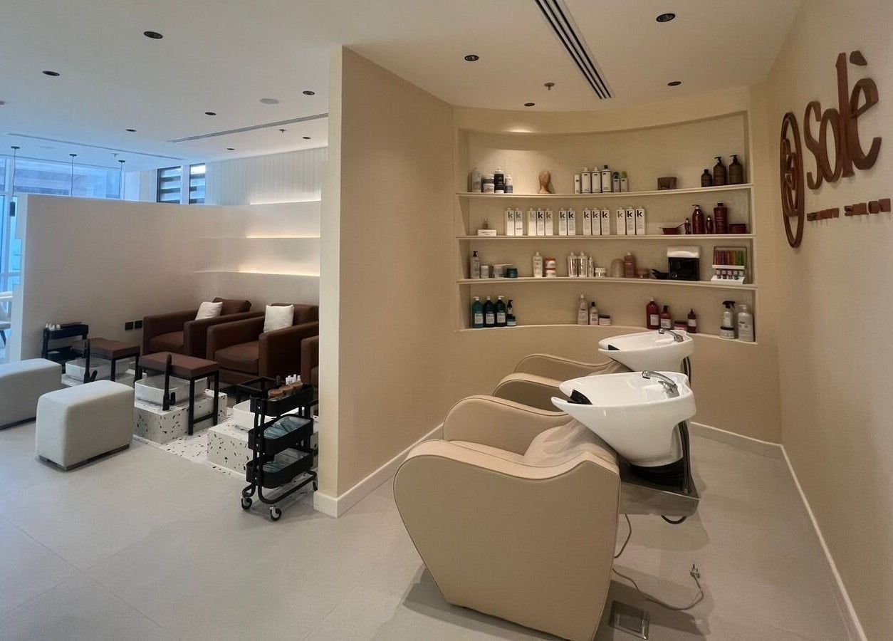 Elegant beauty salon interior at Solè, الظهران, المنطقة الشرقية, SA, featuring chairs and product shelves.