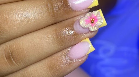 Elegant nail art with a pink flower design at Nailuxebytasha in Willemstad, CW.