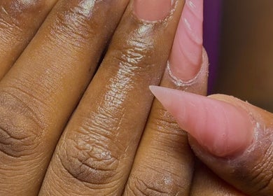 Close-up of styled stiletto nail design at Nailuxebytasha, Willemstad, CW, showcasing intricate artistry.