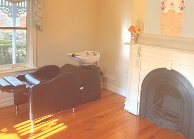 Elegant salon interior at LaBirdie Hair, Frankston Sth, Victoria, AU, featuring a vintage fireplace.