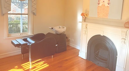 Elegant salon interior at LaBirdie Hair, Frankston Sth, Victoria, AU, featuring a vintage fireplace.