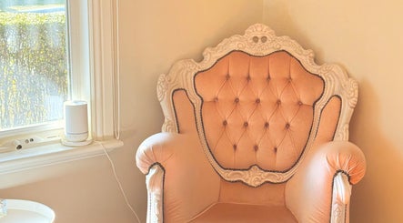 Luxurious peach armchair in LaBirdie Hair, Frankston Sth, Victoria, AU, by a sunlit window.