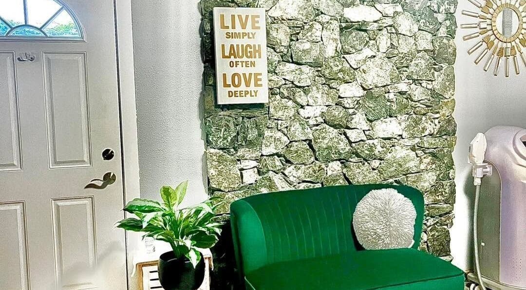 Welcoming nook at Sandy’s H&M in Duncan, BC, with a green couch and wall art inviting relaxation.