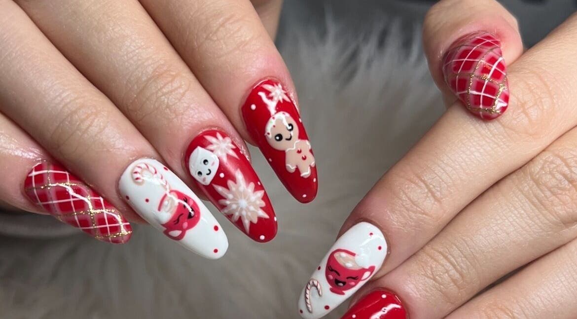 Festive holiday-themed nails at Nailz By Sandy in Adjala-tosorontio, Ontario, CA. Red and white intricate designs.