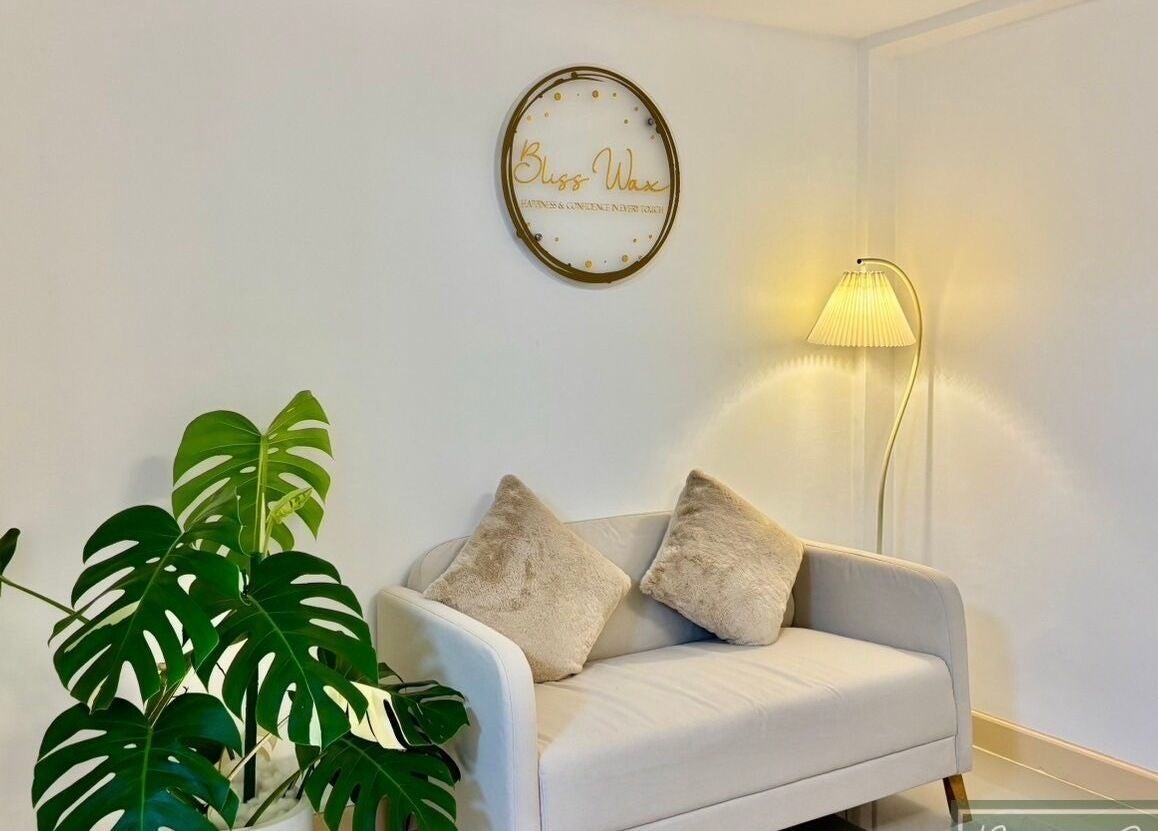 Relaxing seating area at Bliss Wax in ตำบล ศรีสุนทร, ภูเก็ต, TH with plush couch and elegant decor.