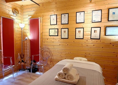 Calming therapy room at Laura Kitto - LMK Complementary Therapist, Rochester, England, GB with warm wood decor.