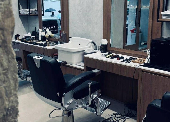 Silent Blue Barbershop interior with sleek barber chair in Hong Kong, HK, reflecting modern elegance.