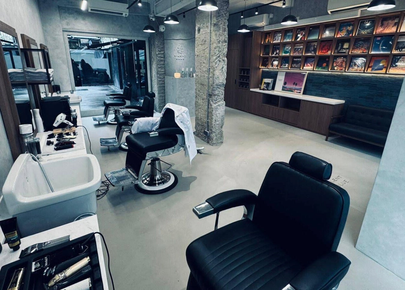 Silent Blue Barbershop interior in Hong Kong, HK with modern chairs and styling tools.