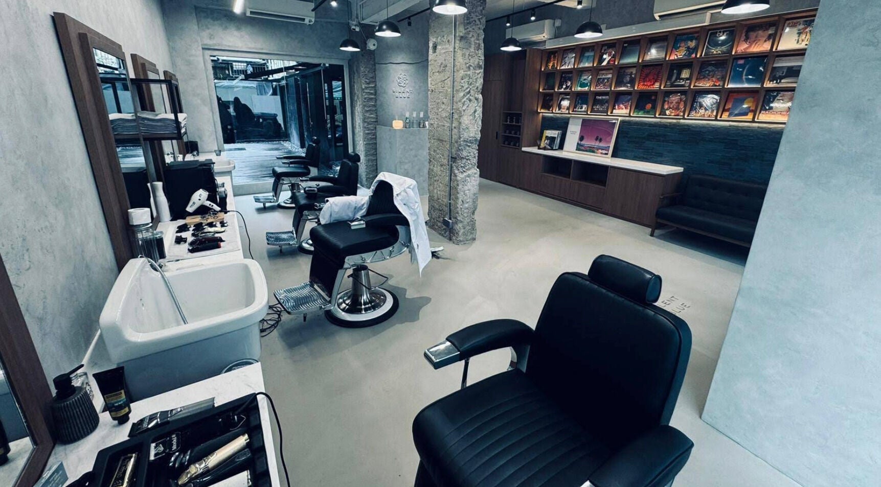 Silent Blue Barbershop interior in Hong Kong, HK with modern chairs and styling tools.
