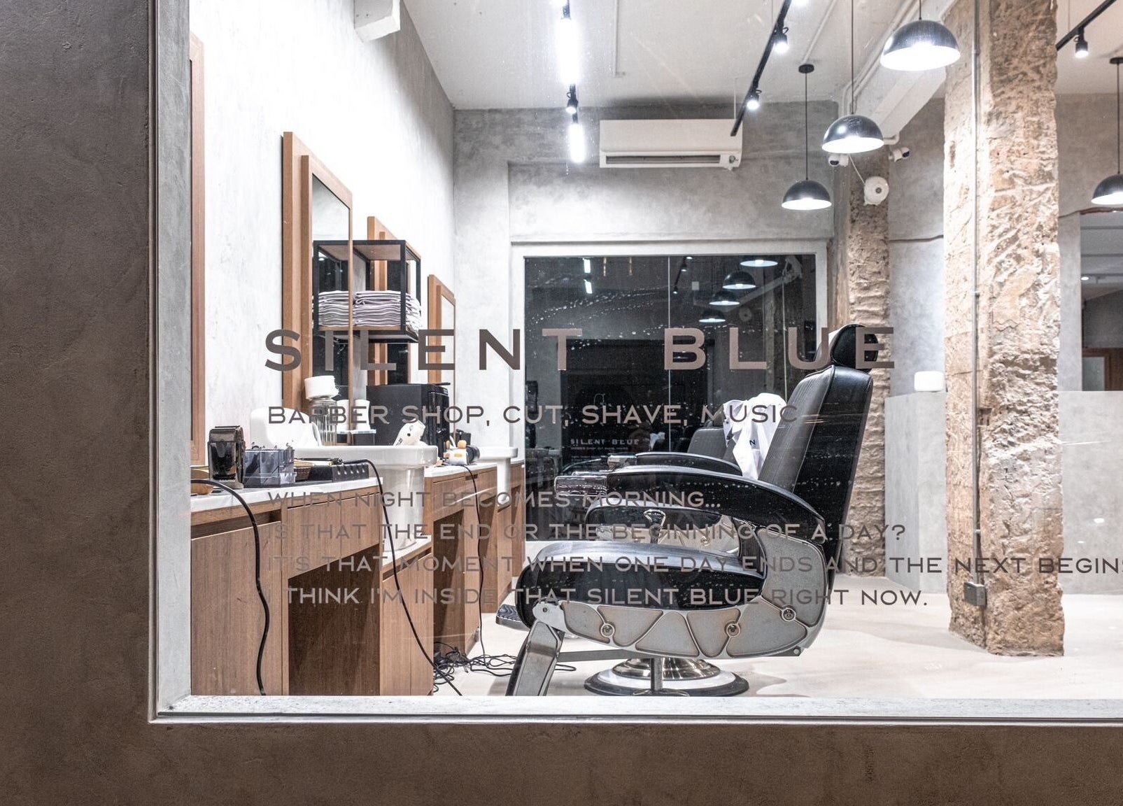 Interior of Silent Blue Barbershop, Hong Kong, HK, showcasing stylish haircut station and modern decor.
