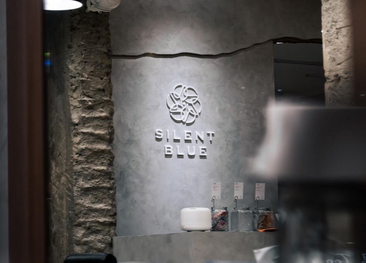 Silent Blue Barbershop interior showing elegant branding with textured walls in Hong Kong, HK.