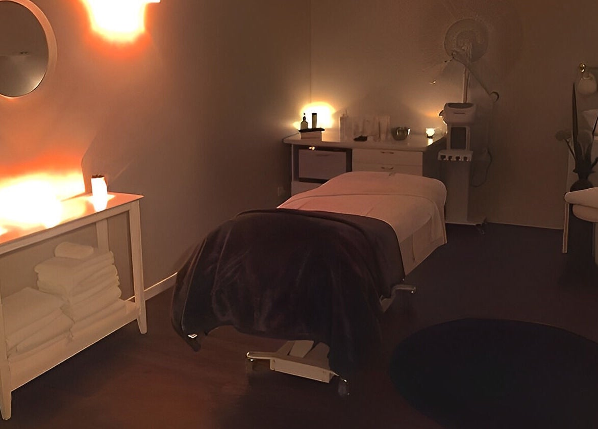 Relaxing massage room at Nourish Spa and Skin Clinic, Melbourne, VIC, AU with warm lighting and cozy decor.