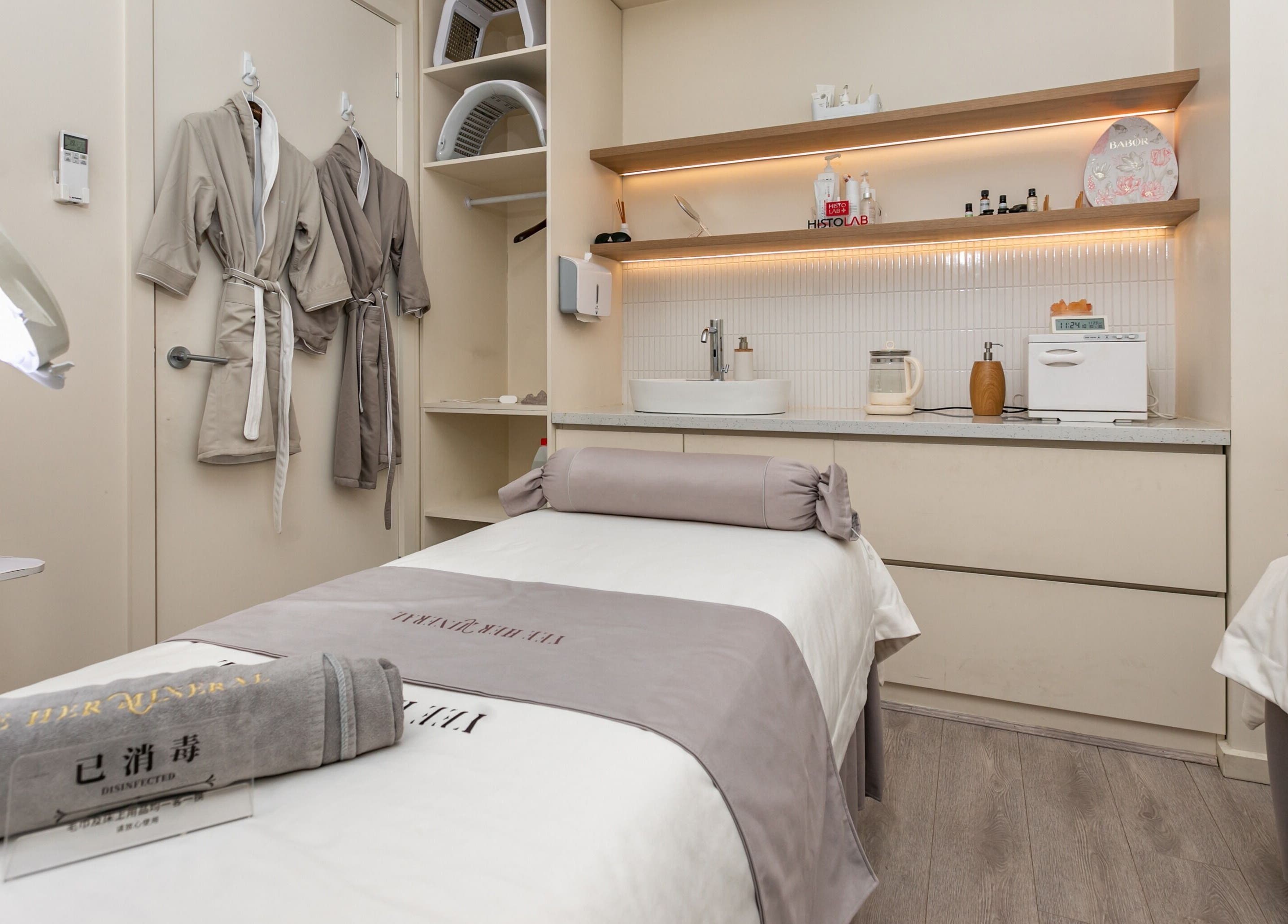 Serene treatment room at Yee Her Mineral, Melbourne, Victoria, AU, featuring plush robes and calming ambiance.