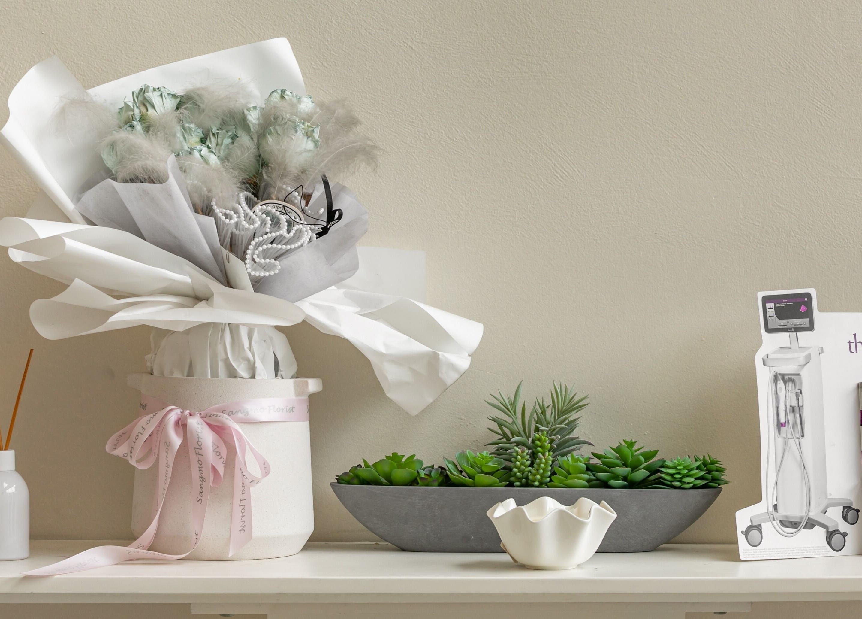 Chic decor at Yee Her Mineral in Melbourne, Victoria, AU with flowers, greenery, and a Thermage FLX display.