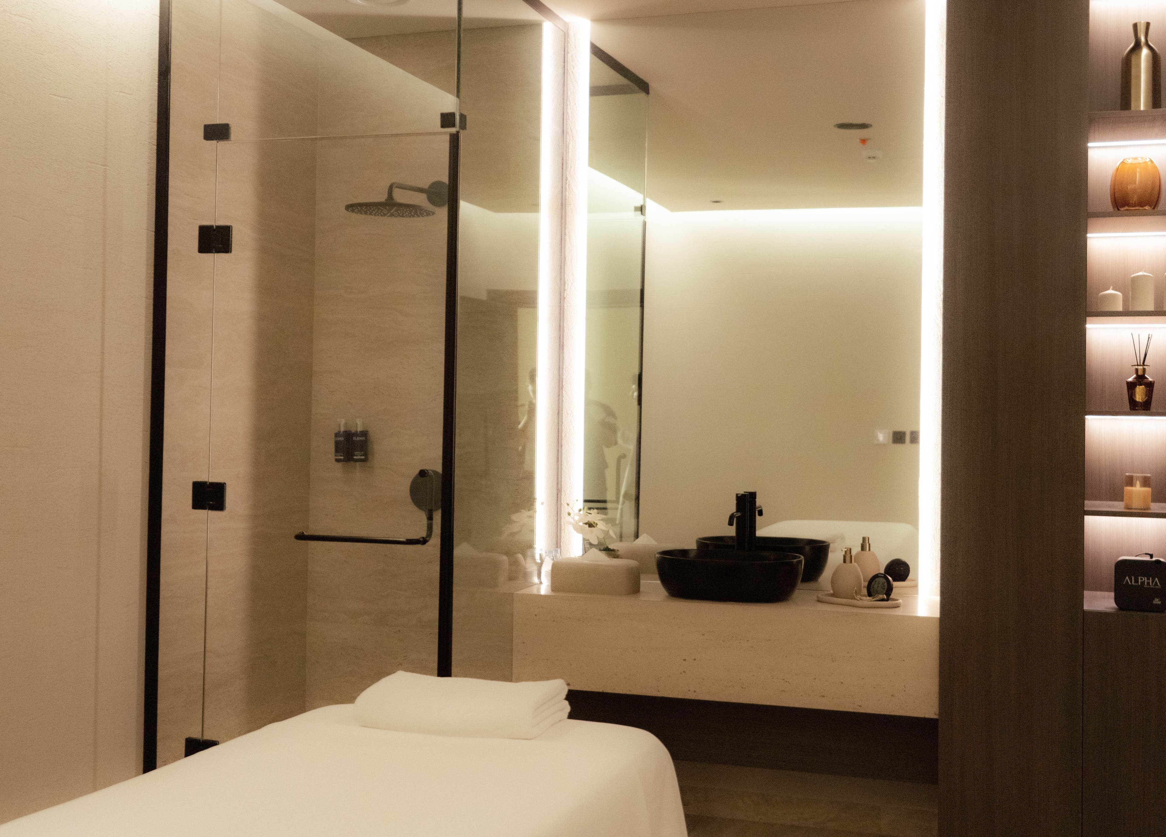 Relaxing massage room at Alpha Spa in Riyadh, Riyadh Province, SA, featuring serene lighting and modern furnishings.