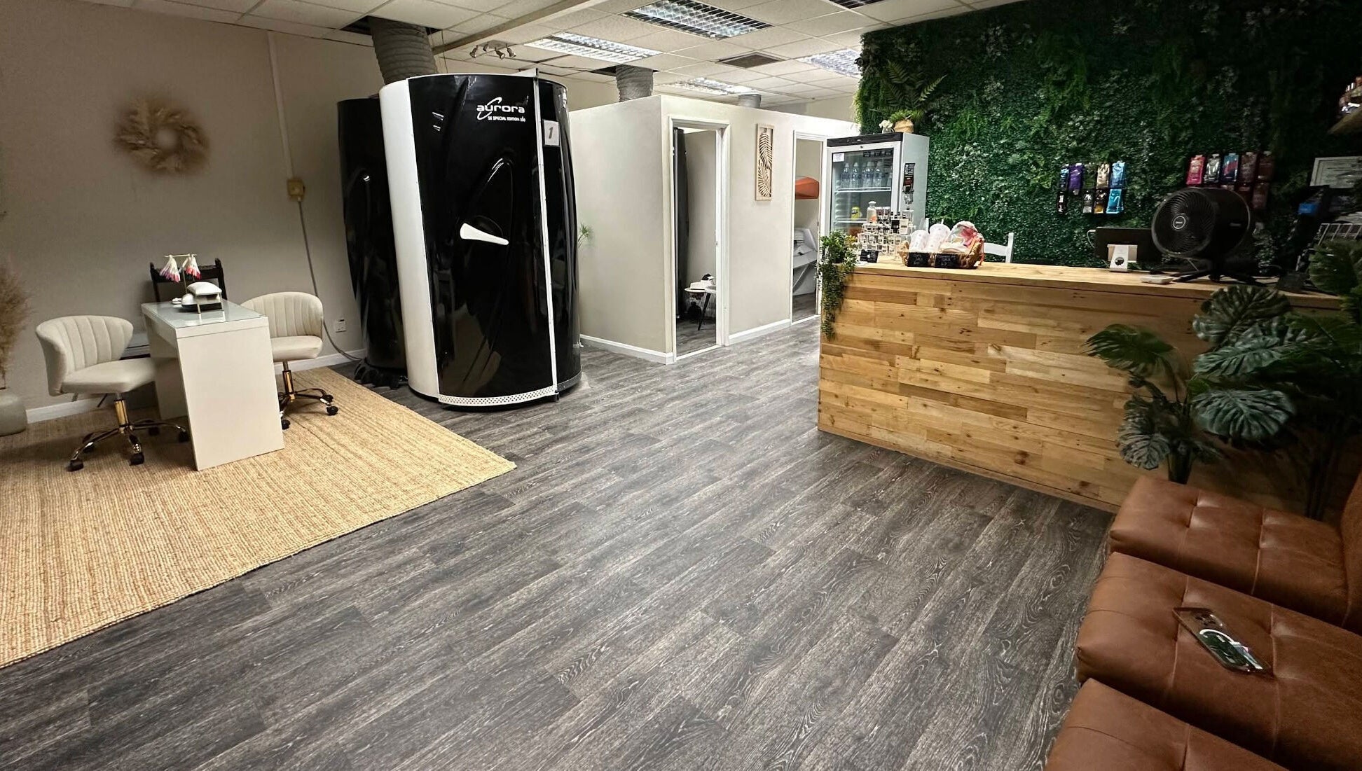 Inside Premier Tanning in Brigg, England, GB, with a sleek tanning booth and cozy seating area.