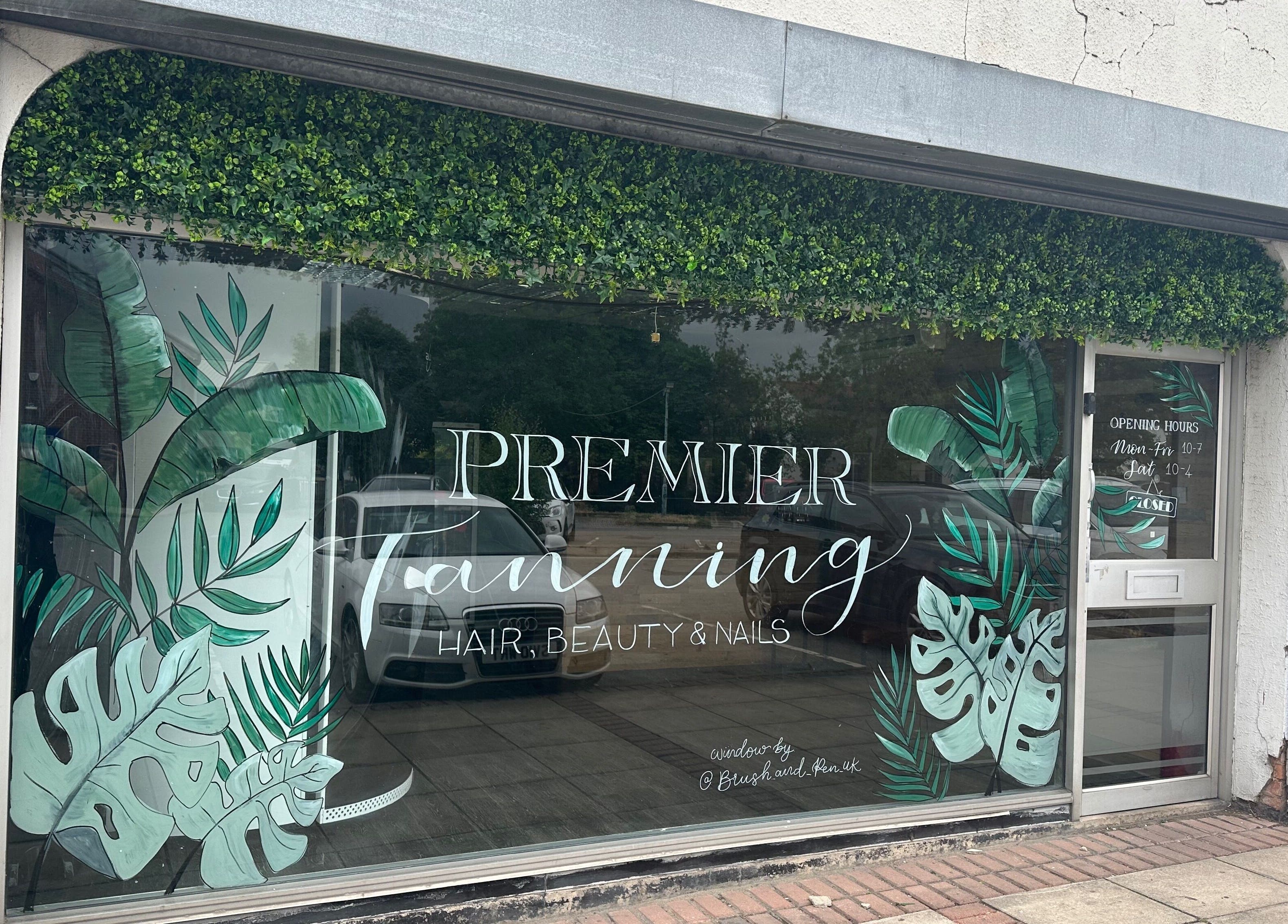 Premier Tanning storefront with vibrant green leaf decor, located in Brigg, England, GB.