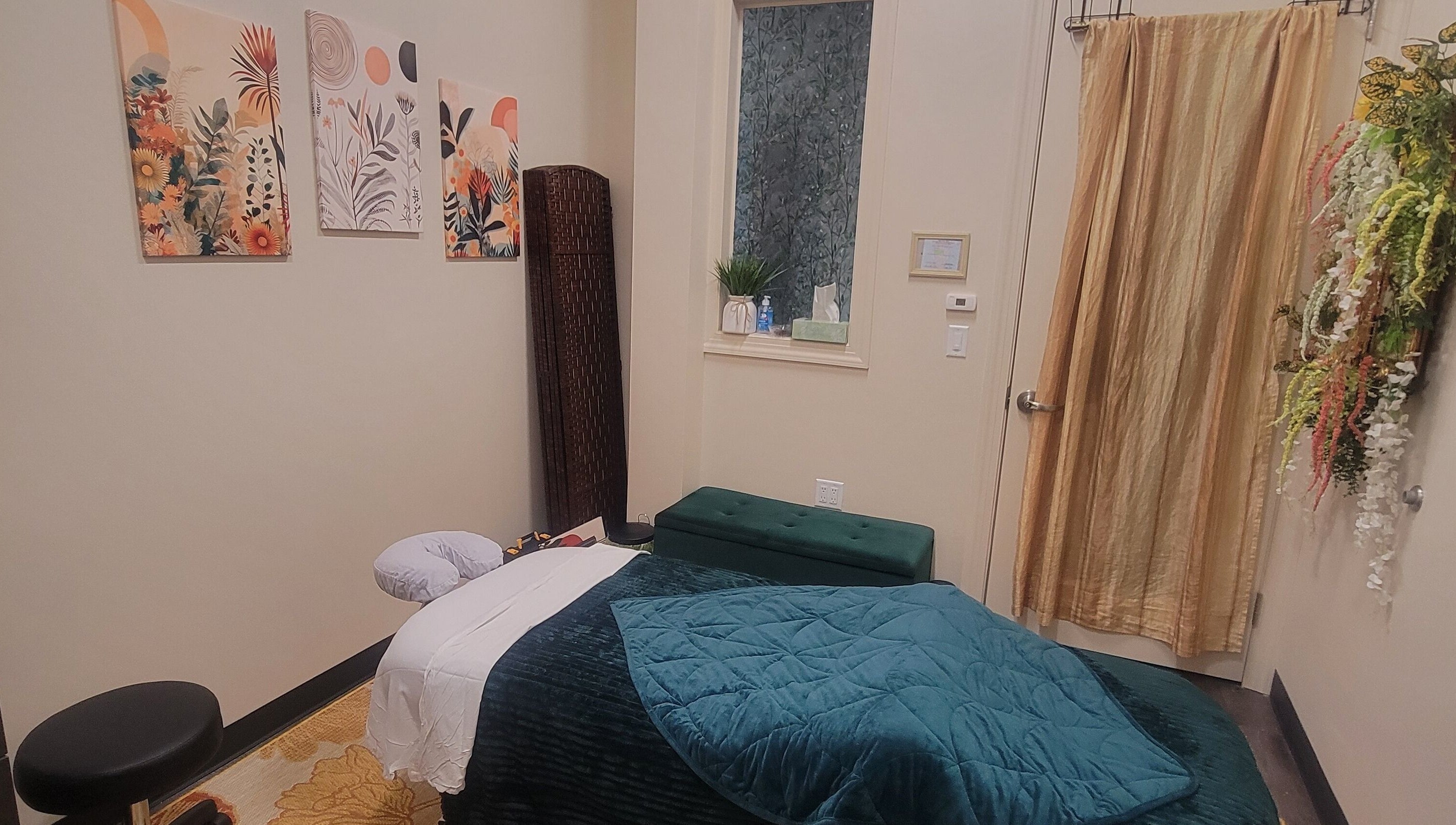 Cozy massage room at Taylored Spa and Massage, Bayonne, New Jersey, US with warm decor and relaxing ambiance.