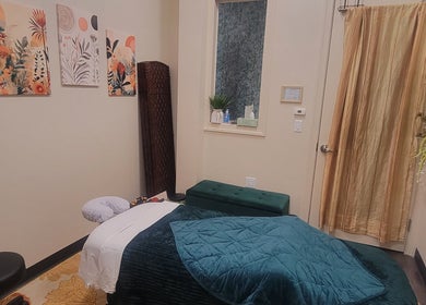 Cozy massage room at Taylored Spa and Massage, Bayonne, New Jersey, US with warm decor and relaxing ambiance.
