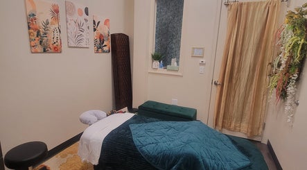 Cozy massage room at Taylored Spa and Massage, Bayonne, New Jersey, US with warm decor and relaxing ambiance.